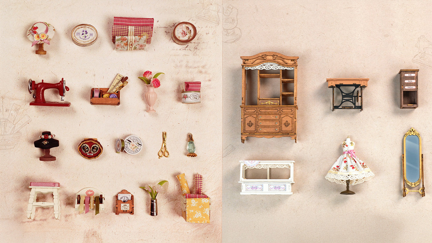 This image showcases the entire miniature tailoring set featuring a red sewing machine a wooden display cabinet a small dress mannequin and numerous tiny spools and notions