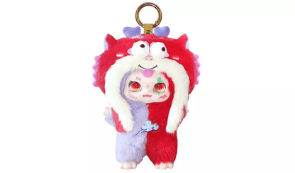 Furry red and purple split-colour doll keychain wearing a large red monster hood with white trim