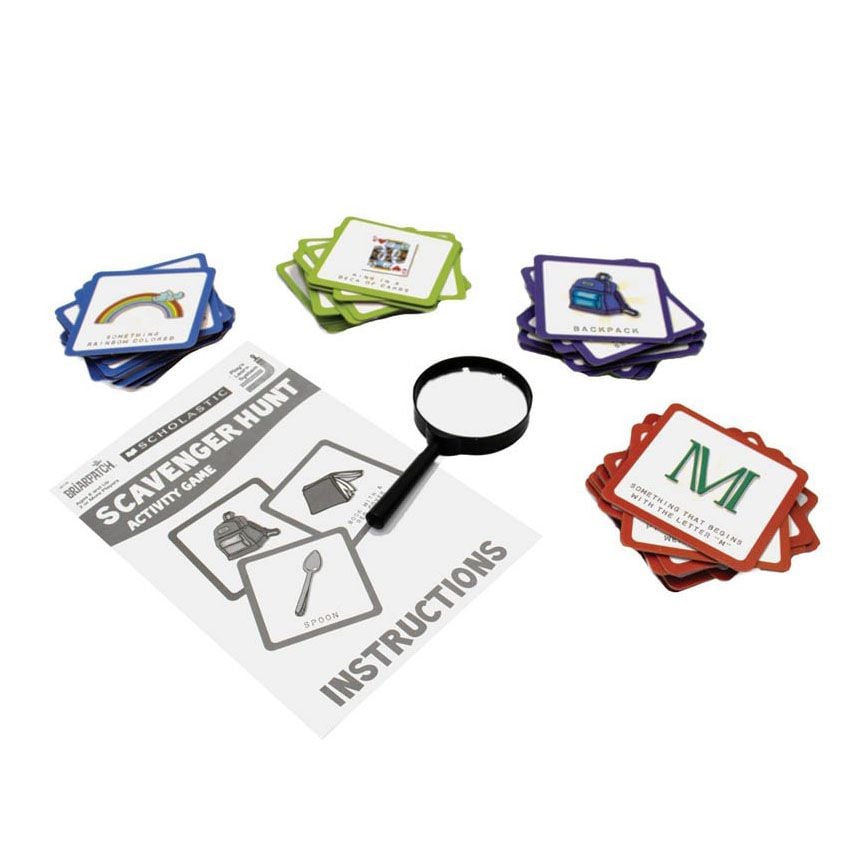 Scholastic Scavenger Hunt activity game with instructions, magnifying glass, and stacks of colourful game cards featuring challenges like 'Rainbow Coloured' and 'Backpack'