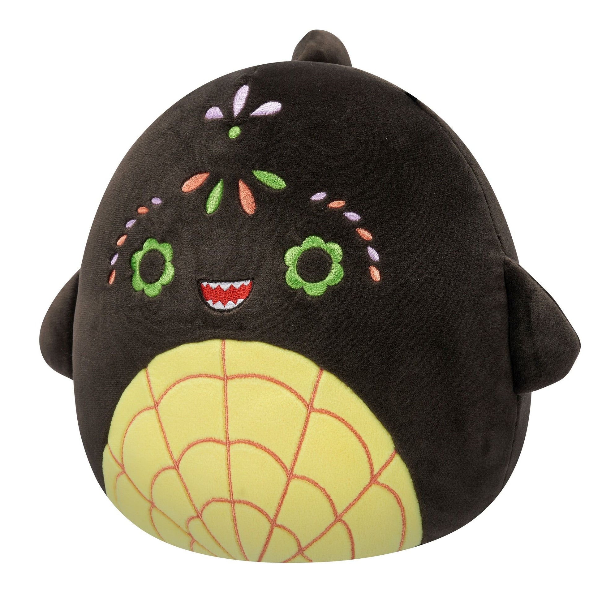 A dark brown Squishmallow plush with green flower eyes, a toothed smile, colorful embroidered flowers, and a yellow spiderweb belly