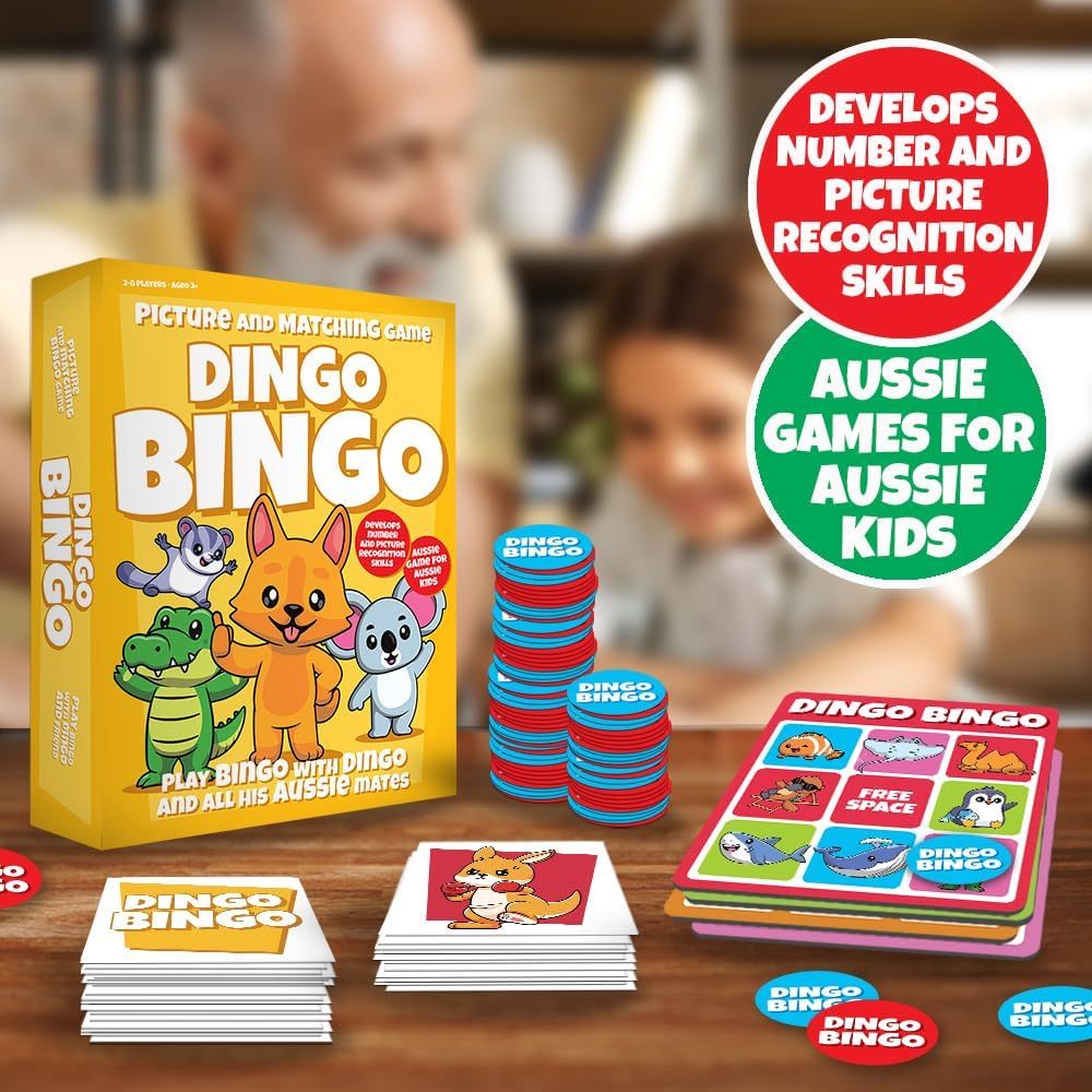Dingo Bingo picture and matching game box, cards, and chips displayed on a table with blurred adults and kids in the background