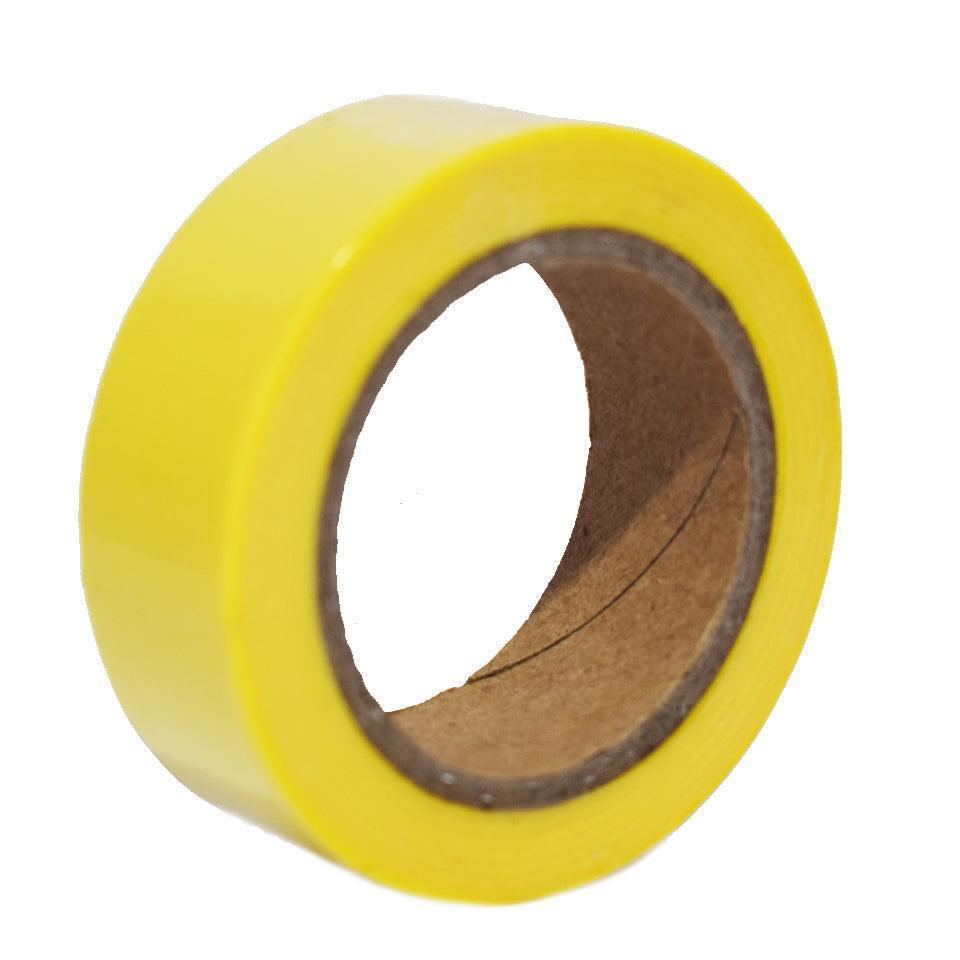 A single roll of bright yellow masking tape with a brown cardboard core is shown against a white background