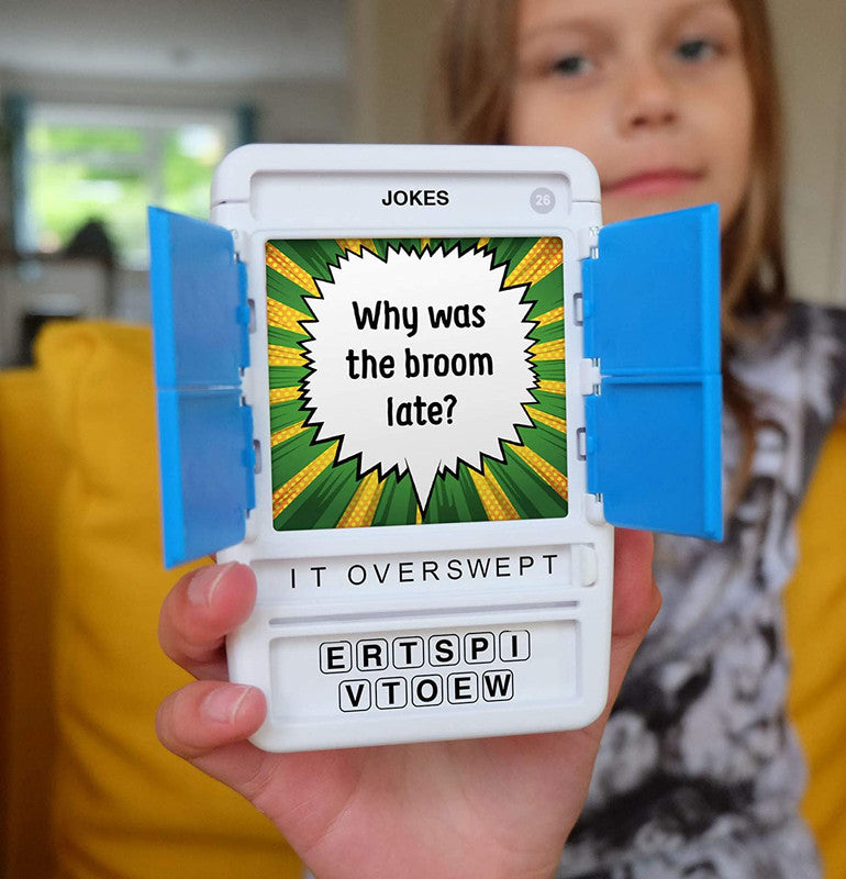 Child holds a white joke game with blue doors open displaying the question Why was the broom late and the answer letters IT OVERSWEPT below