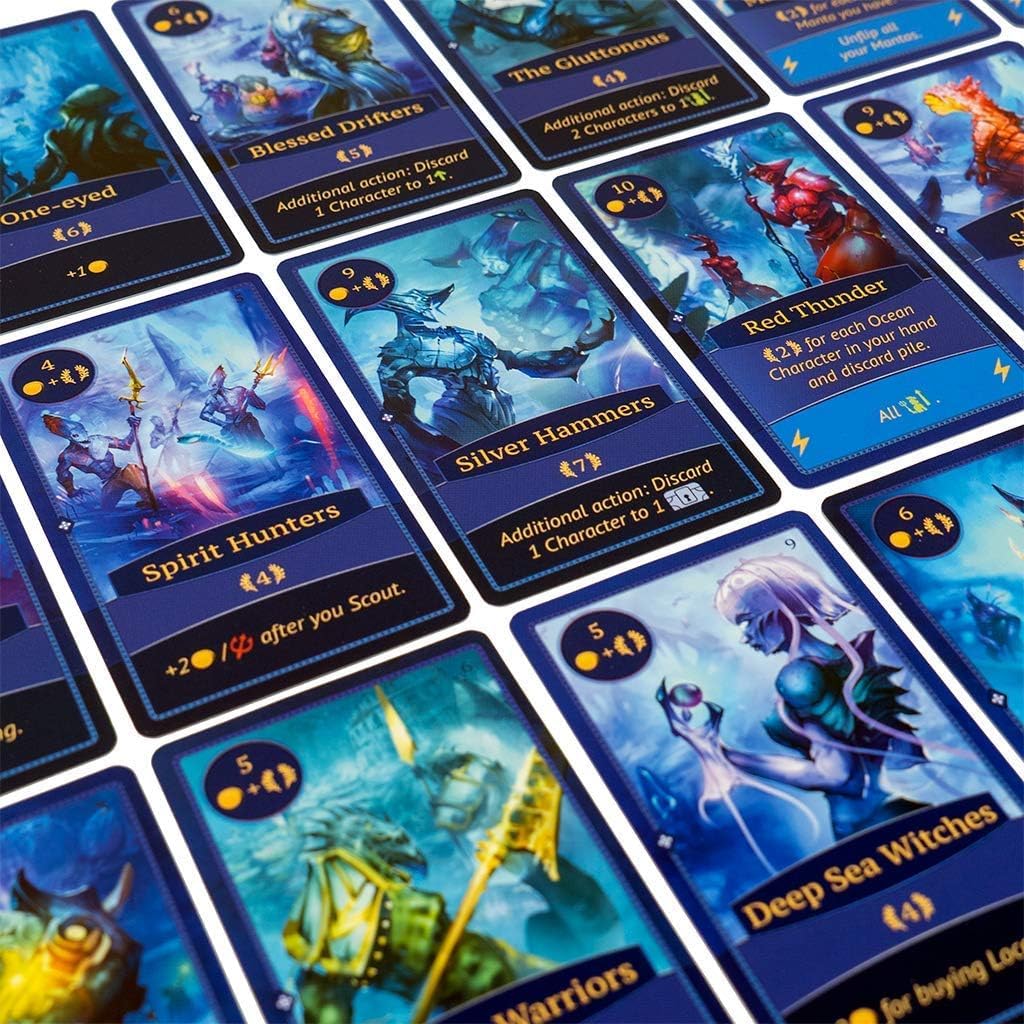 A close-up view of several dark blue fantasy game cards with various creature illustrations and game text, arranged on a surface