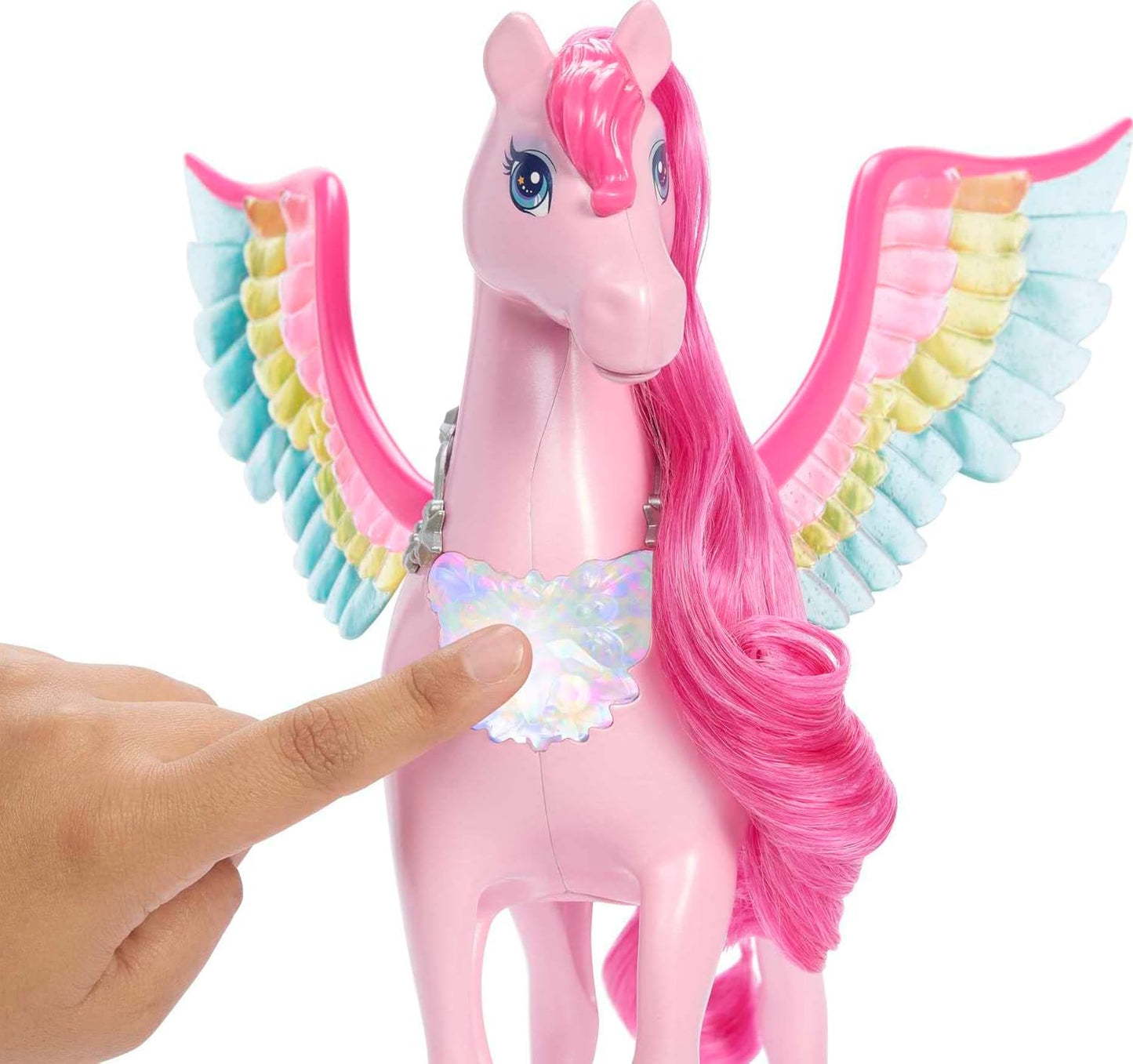 A finger presses the iridescent chest piece of a pink Pegasus toy with pink mane and rainbow wings
