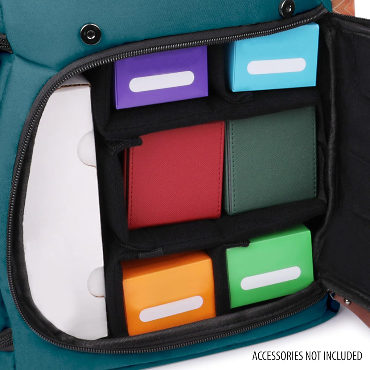 An open teal bag with organized compartments holding a tall white box and several colorful cases and boxes.