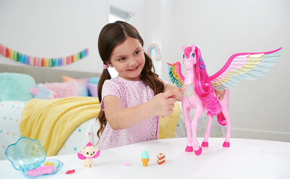 A smiling girl touches a large pink Pegasus toy with vibrant rainbow wings