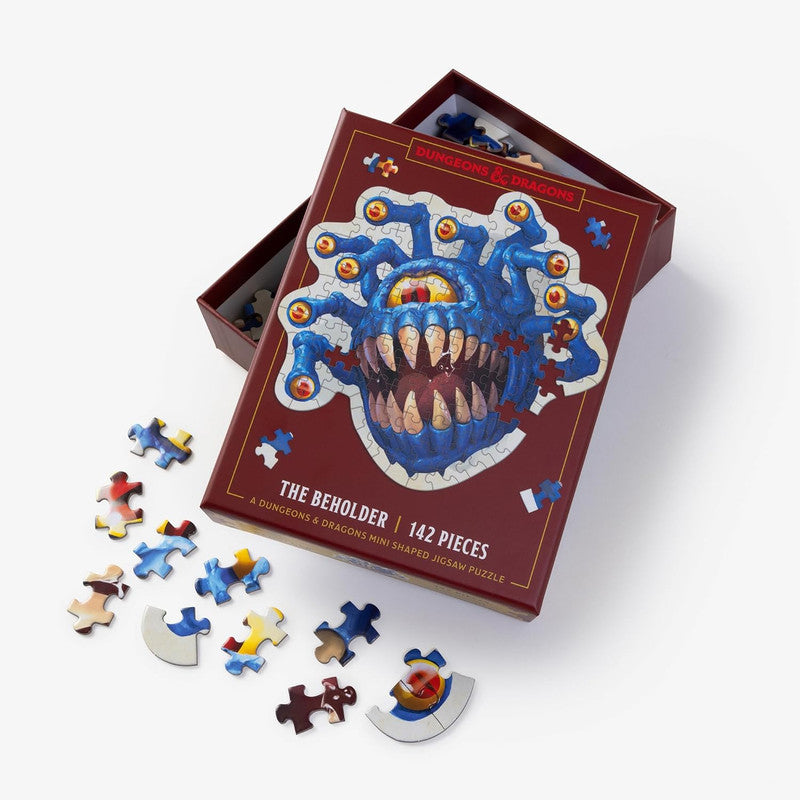Dungeons &amp; Dragons &#39;The Beholder&#39; 142-piece mini-shaped jigsaw puzzle box, open with scattered pieces