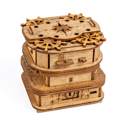 Intricate wooden mechanical Davy Jones Locker puzzle box, decorated with ship wheels and a compass rose
