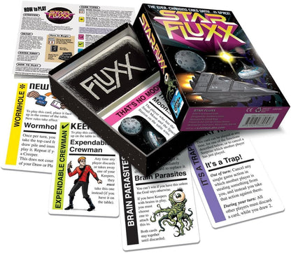 Star Fluxx sci-fi card game box, open to show branded cards, rule sheet, and various game cards with spaceships and alien creatures.
