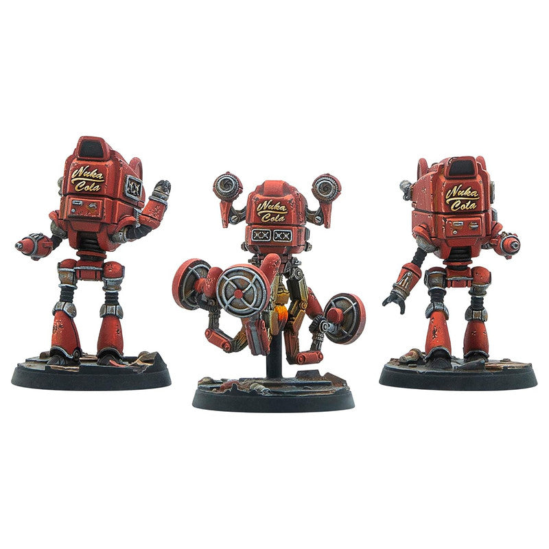 Three weathered red Nuka Cola robot miniatures: one standing, one hovering with large propellers, and one standing, on wargaming bases