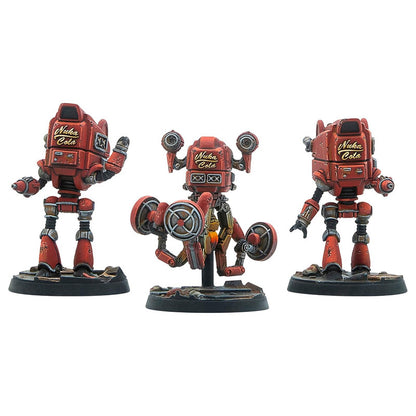 Three weathered red Nuka Cola robot miniatures: one standing, one hovering with large propellers, and one standing, on wargaming bases