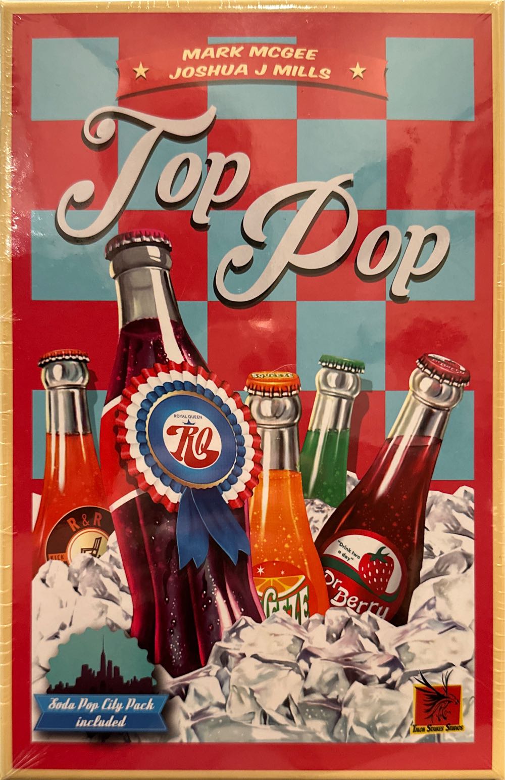 Box cover featuring colorful soda bottles arranged in rows against a bright, stylized city skyline background