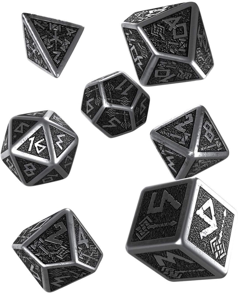 Dwarven Metal Dice Piece Set, Seven ornate silver polyhedral dice with dark textured faces and fantasy runes, scattered