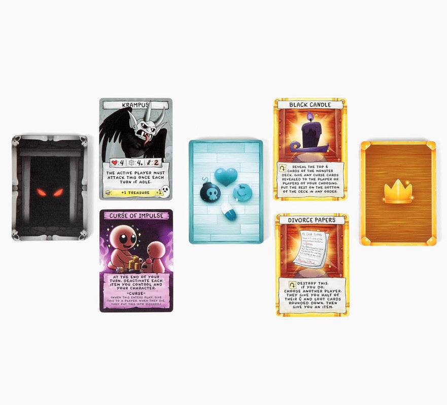 Tabletop card game components laid out, including monster and item cards, and tokens like a heart and skull bomb
