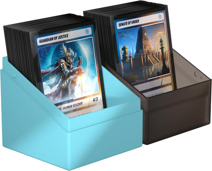 Two stacks of collectible trading cards stored in side-by-side blue and dark plastic deck boxes