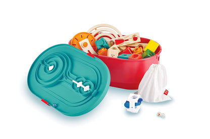Colorful modular marble run toy set in an open red storage bin with a teal track lid