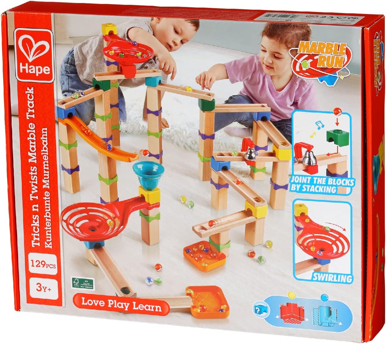 Two children playing with a large, colorful wooden marble run track featuring ramps and specialized components