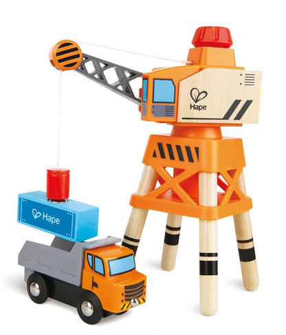 Wooden construction toy set: orange crane loading a blue container onto a dump truck