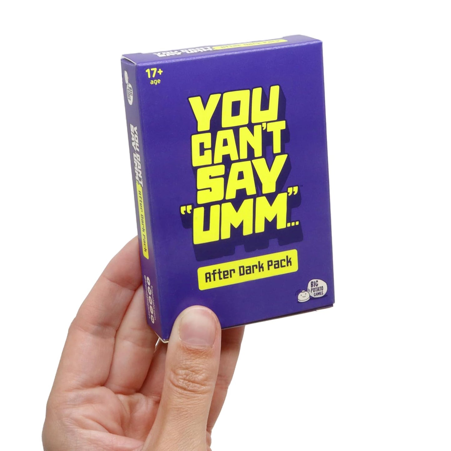 Hand holds the "You Can't Say 'Umm...' After Dark Pack" card game box