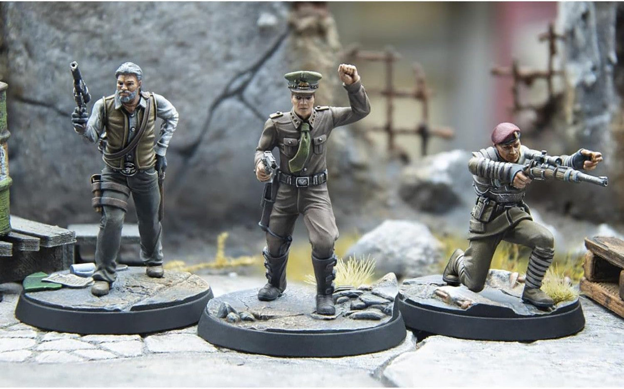 Three painted wargaming miniatures: a man holding a pistol, an officer with a raised fist, and a sniper aiming a rifle