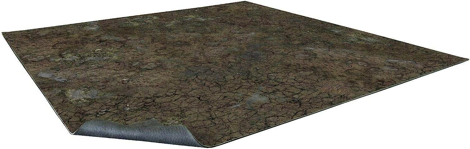 A rectangular battle mat with a cracked, muddy terrain design. A corner curls, revealing its dark, textured underside.