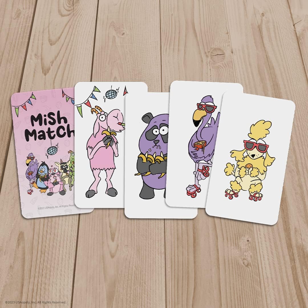 Mish Match card game with pink cover and five character cards including a goat panda flamingo and poodle all on a wooden surface