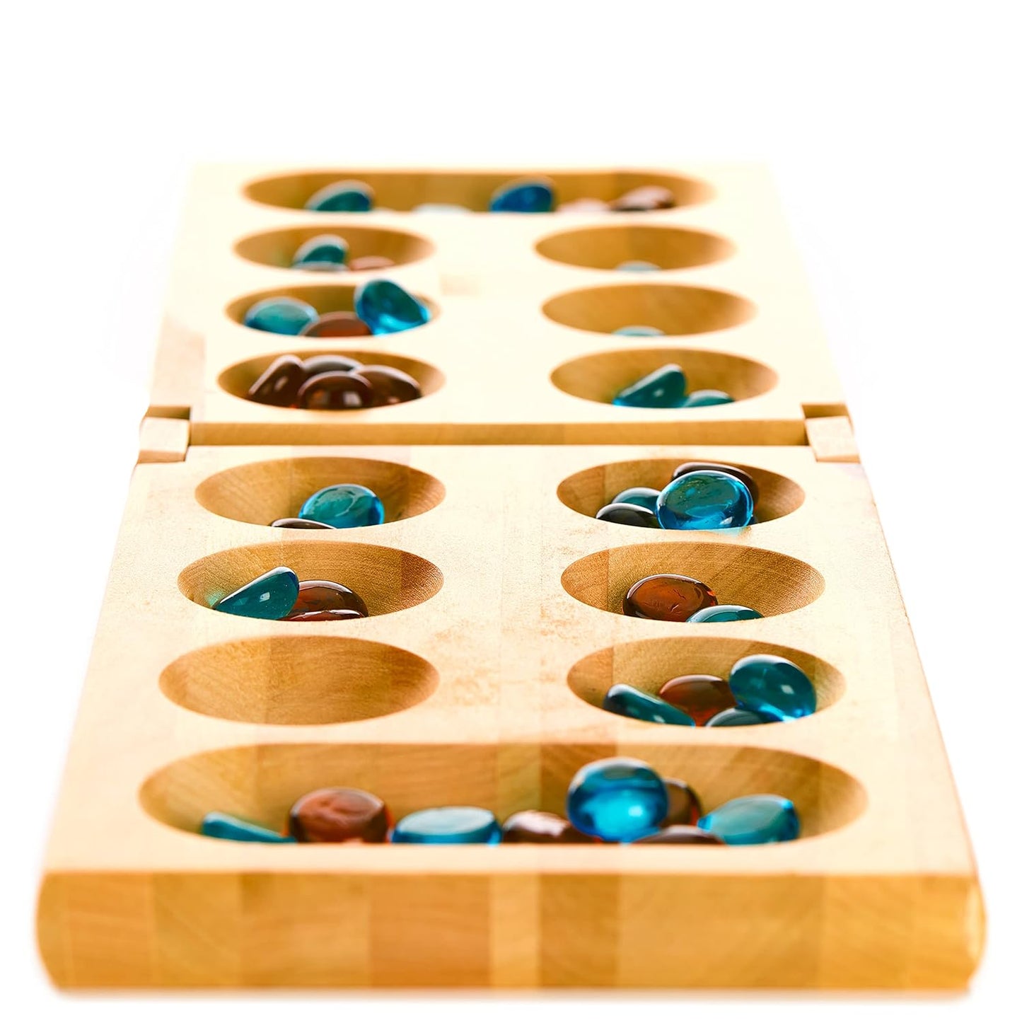 A wooden Mancala game board filled with blue and amber glass stones