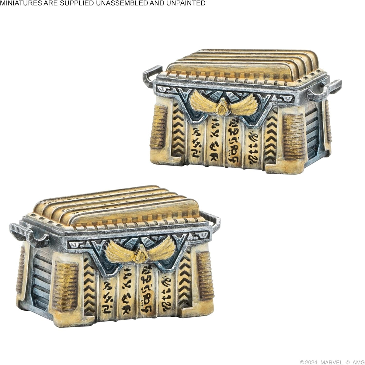 Two ornate gold and silver miniature treasure chests with ancient Egyptian-style designs