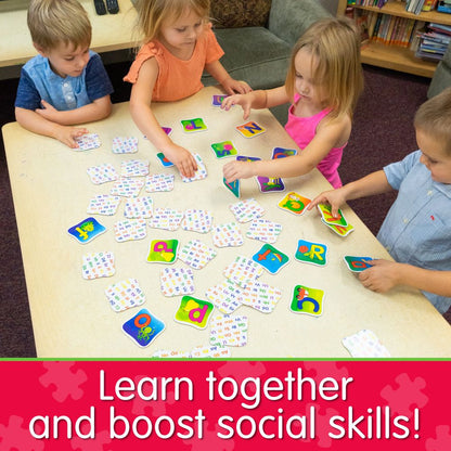 Four young kids playing an alphabet matching game with letter flashcards on a table