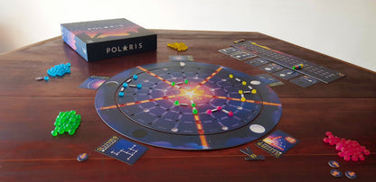 Polaris board game setup on a wooden table featuring the circular game board multiple colored player pieces and rule cards