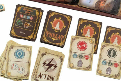 Close-up of steampunk-themed board game cards, including "Threat" and "Mechanical Wasps", with a die and board