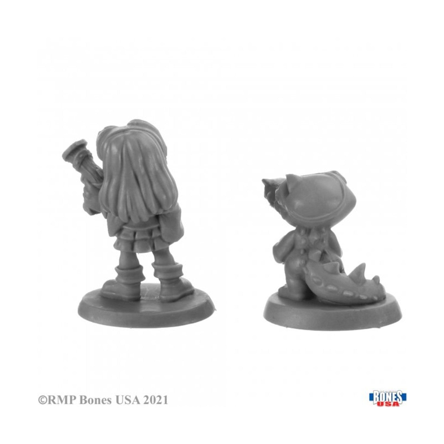 Unpainted plastic miniatures, back view: female figure with rifle and character wearing a crocodile costume