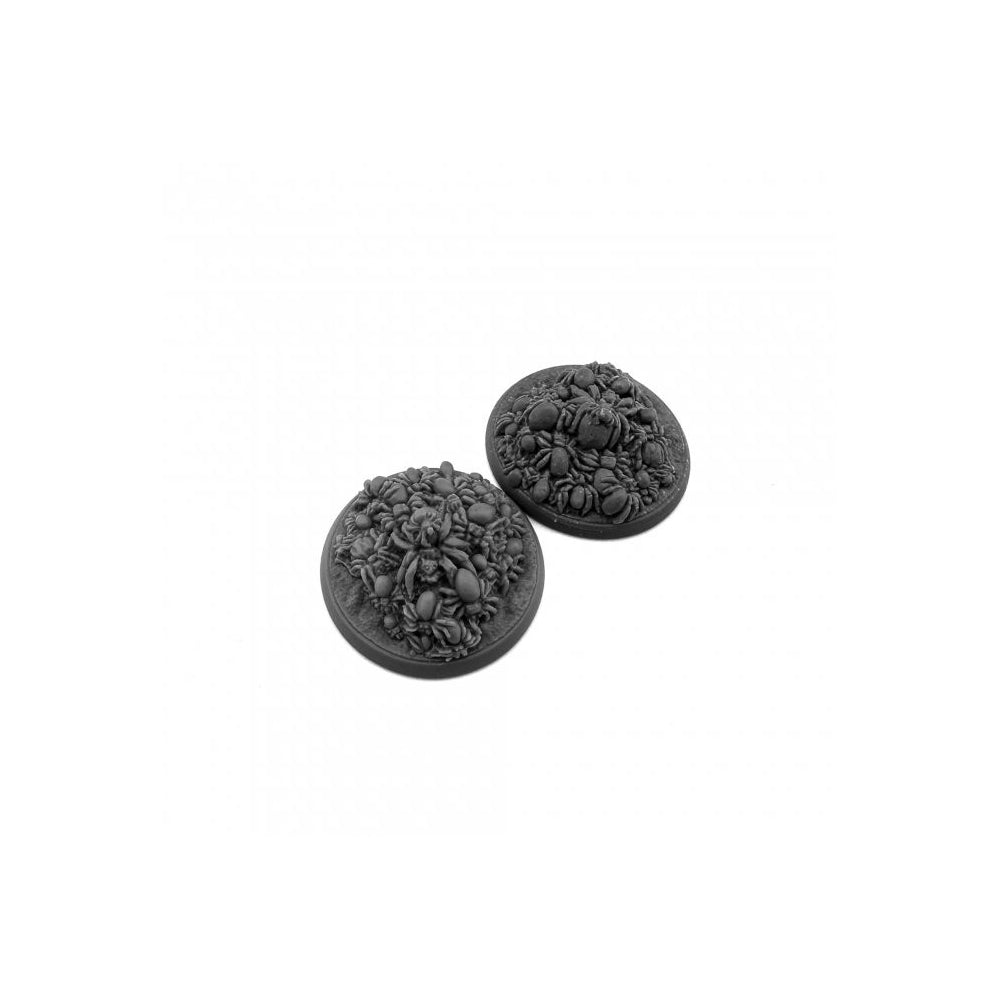 Two gray miniature bases sculpted with a dense spider swarm design for fantasy wargaming terrain and basing