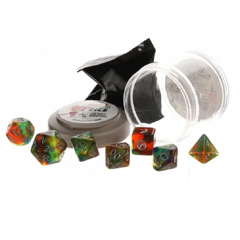 Seven colorful swirled Pizza Dungeon Dice lie scattered near an open gray container, a black wrapper, and a clear plastic tube