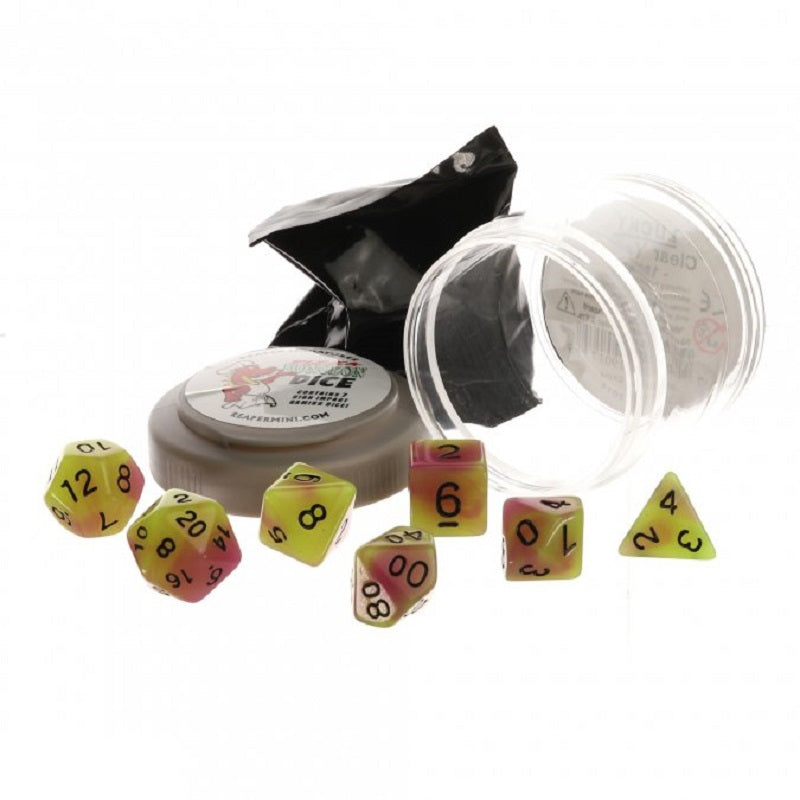Seven yellow and purple swirled Reaper Pizza Dungeon Dice Glow are scattered with their small container and clear plastic packaging