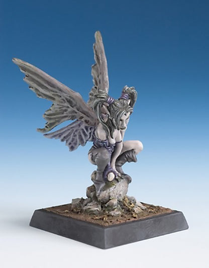 Painted fantasy miniature of a crouching dark fairy or sylph with large tattered grey wings, resting on a stone base