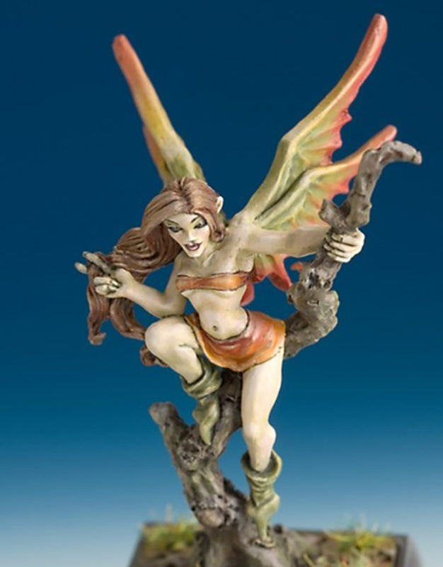 Fantasy miniature of a fairy with large orange and green wings, perched on a twisted root or tree stump