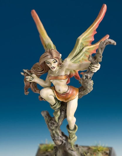 Fantasy miniature of a fairy with large orange and green wings, perched on a twisted root or tree stump