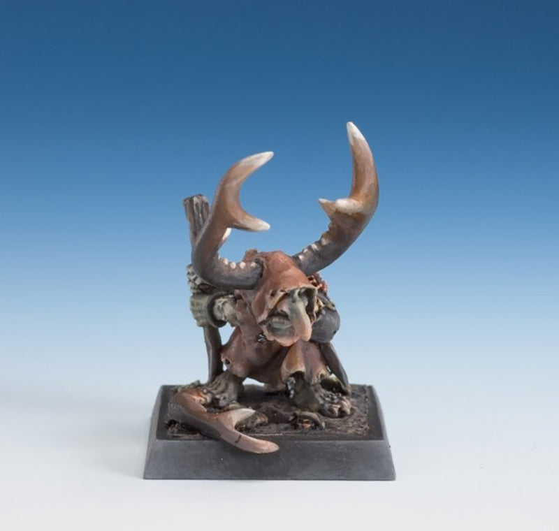 Painted miniature of a hunched goblin or shaman figure with a long nose and giant curved antlers/horns