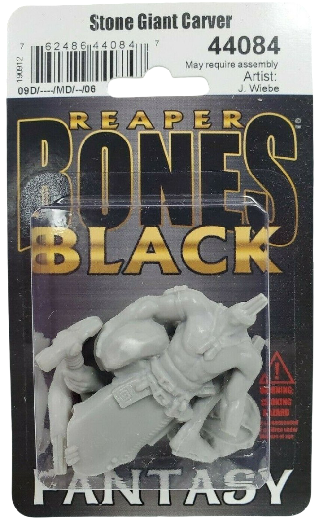 A grey unassembled Stone Giant Carver miniature figure in clear plastic packaging attached to a black card backing