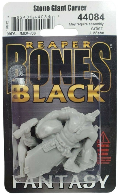 A grey unassembled Stone Giant Carver miniature figure in clear plastic packaging attached to a black card backing