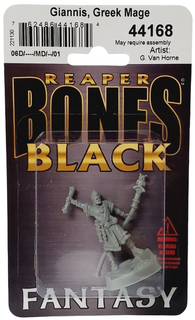A gray plastic miniature of Giannis, Greek Mage, holding a scroll and an owl-topped staff, packaged in clear plastic on a dark card