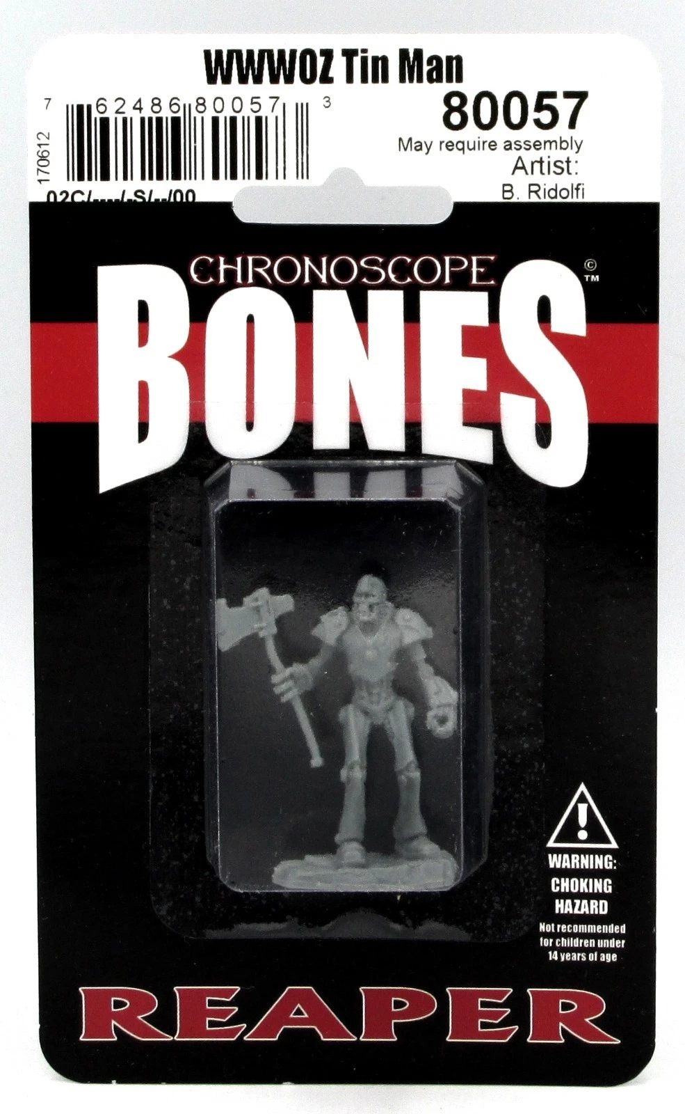A Reaper Chronoscope Bones WWWOZ Tin Man miniature, a gray unpainted skeletal figure wielding an axe, sealed in a black blister pack featuring white and red logos