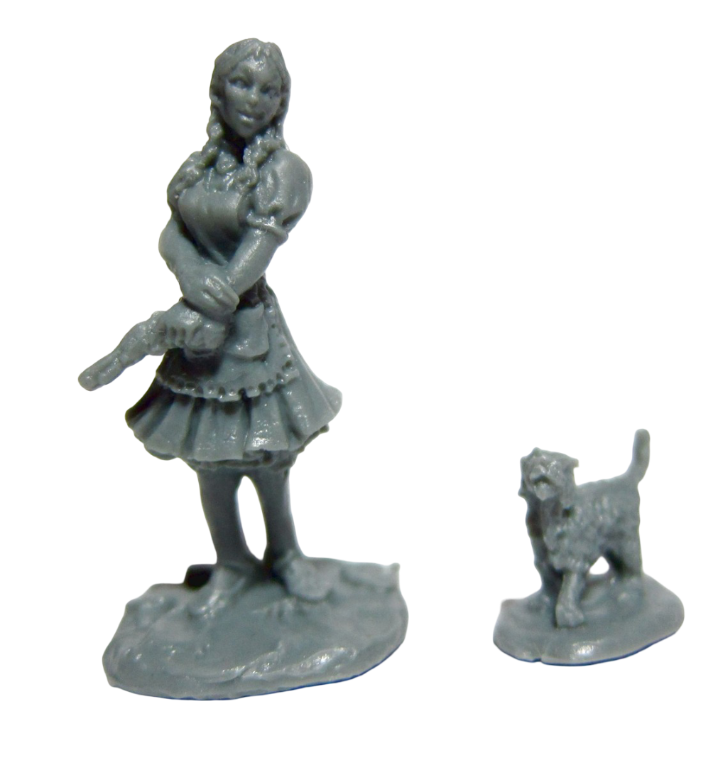 A grey miniature of Wizard Of Oz Dorothy with braided hair and a ruffled dress holding an object, next to a small dog