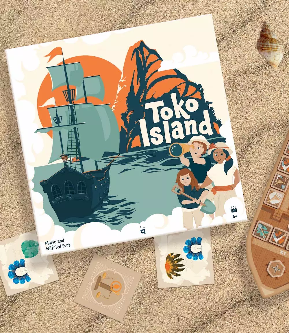 Toko Island game box and components displayed on sand