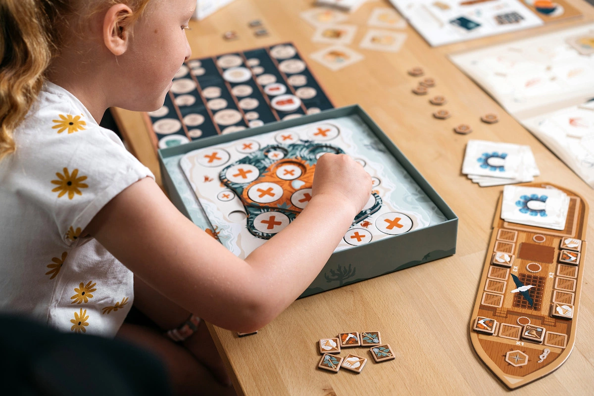 Toko Island in progress with kids interacting with the game pieces