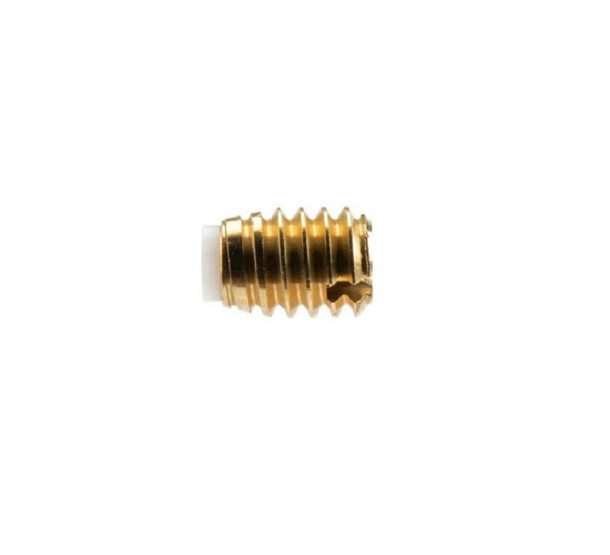 A golden threaded packing screw and seal with a white tip
