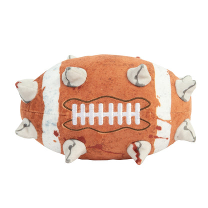 The plush Blood Bowl football is brown and white with embroidered laces, several soft spikes, and red splatter patterns