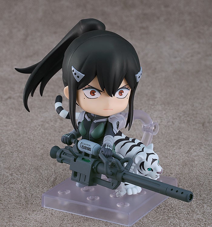 Dynamic action pose with one foot forward, bazooka aimed outward, and sunglasses lifted to reveal her eyes